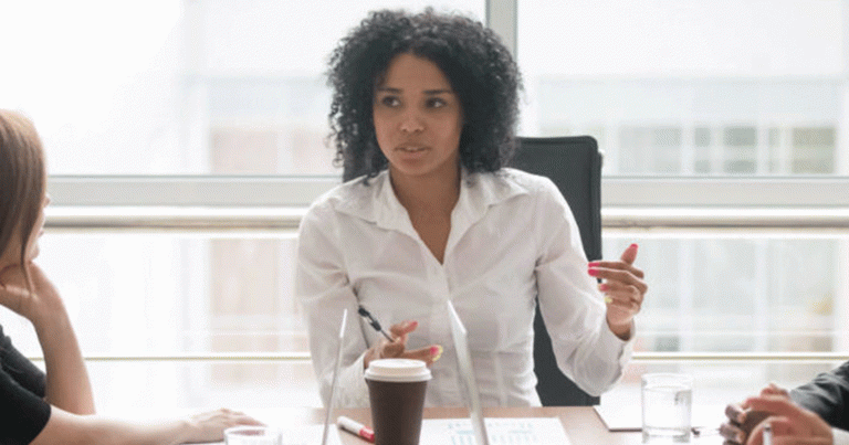 African American woman speaking in a business meeting