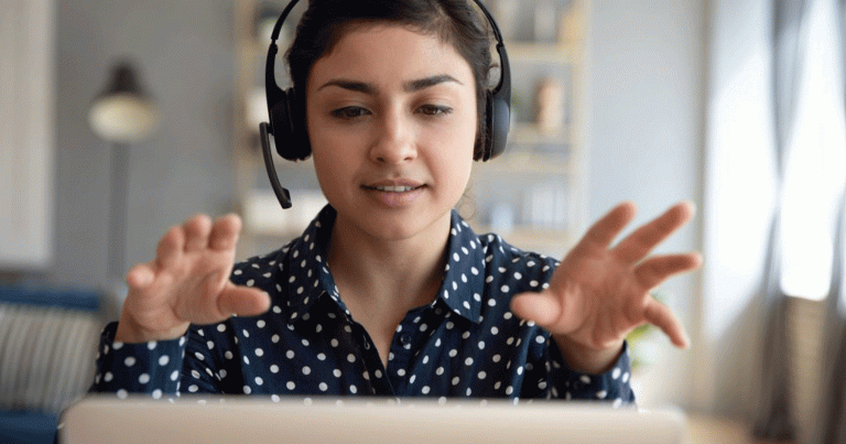 Indian young business woman student teacher tutor wear wireless headset video conference calling on laptop computer talk by webcam learn teach in online chat, distance webinar online teaching concept